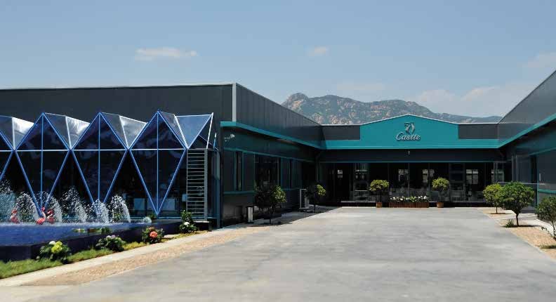 Exterior of the Ariel Fashion factory with mountains behind