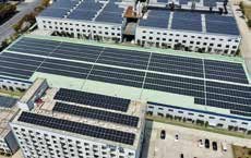 Aerial view of solar panels on a factory roof